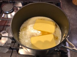 Melting blocks of butter in pan